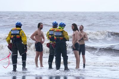 Trio defy storm warnings to strip off for sea dip