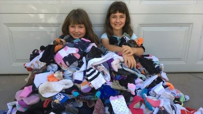 'It's our rubbish, our problem': Canberra sisters commit to saving 10,000 socks from landfill