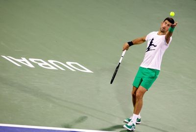 Djokovic finally gets season underway to loud cheers in Dubai