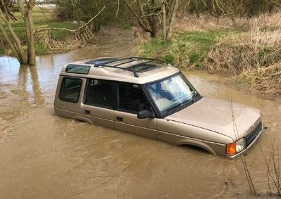 Family with baby rescued from roof of 4×4 stuck in floodwater