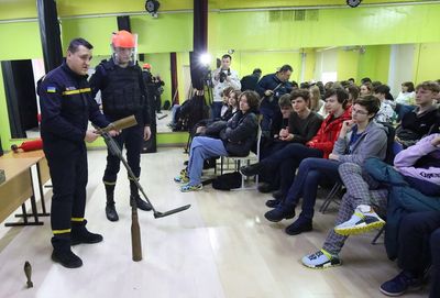 Students try bulletproof vests and escape drills in east Ukraine
