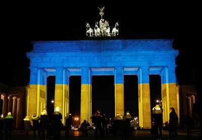 Berlin and Paris illuminate buildings in Ukrainian colours in show of unity