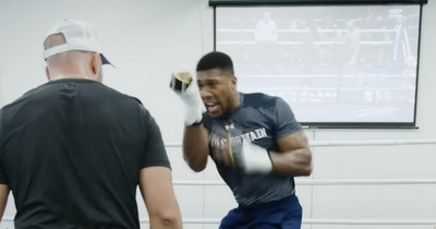 Anthony Joshua spotted training with Tyson Fury fight on in the background