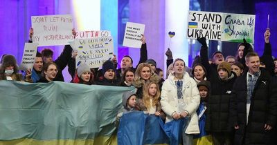 Hundreds including Man City star turn out for Ukraine vigil as darkness falls in our city centre - and Manchester Central Library is bathed in blue and yellow