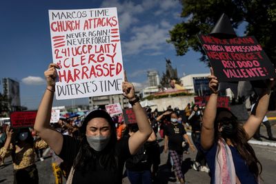 Philippines marks Marcos overthrow as son homes in on presidency