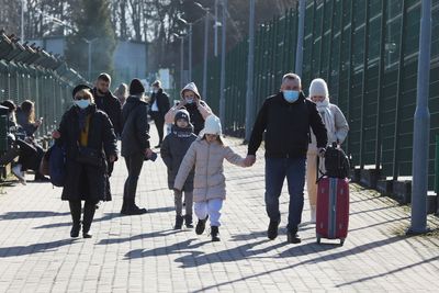 Thousands flee Ukraine into EU, men told to stay and fight