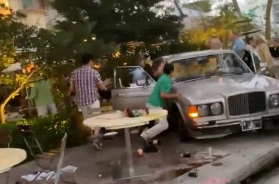 Crowd lifts Bentley off trapped diners after Miami restaurant crash that killed one and injured six