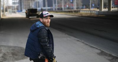 Volunteers make Molotov cocktails and parade through streets as Ukraine fights back