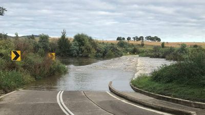 ACT crossings closed after 'tropical air from the north' leads to heavy rainfall