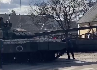 Ukrainian man kneels in front of Russian tank after trying to stop it with his bare hands