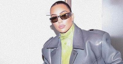 Kim Kardashian ignores the divorce drama and poses in full green latex suit