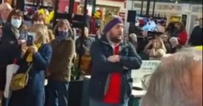 Male voice choir break into song inside Swansea Market