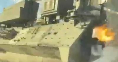Ukrainian civilians throw molotov cocktail at Russia tank in brave drive-by attack