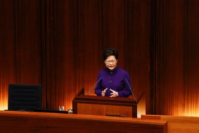 Hong Kong’s leader urges calm as lockdown fears spur panic buying
