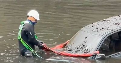 Specialist divers on site at Gleniffer Braes as cars are prepared for removal