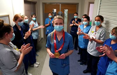 Curling gold medal-winning nurse moved to tears on return to work