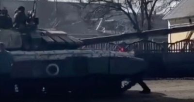 Moment man 'stops Russian tank with bare hands' as unarmed Ukrainians confront soldiers