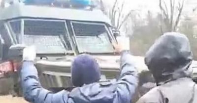 Ukrainian civilians bravely take on Russian tanks as they scream 'killers' at invaders