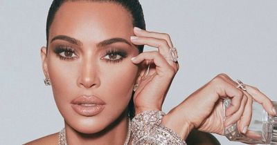 Kim Kardashian poses topless with diamond necklace for risqué KKW fragrance advert