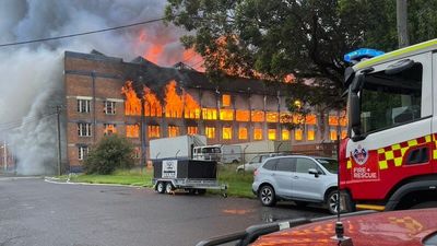 Newcastle woolstore buildings destroyed, but fuel depot spared from raging warehouse fire