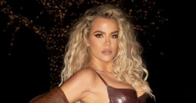Khloe Kardashian shows off natural curls as she squeezes into 'wet' latex catsuit