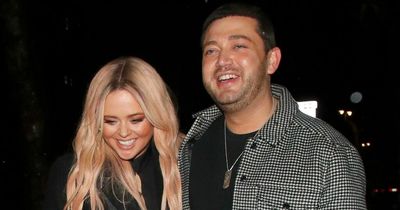 Emily Atack cosies up to male pal as she leaves party in a blinding photography storm
