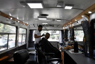 Venezuelan barber mounts mobile shop amid economic crisis