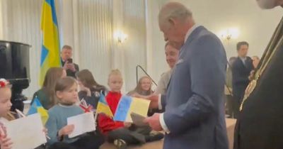 Prince Charles handed 'Stop Putin' poster from young girl as he praises brave Ukrainians