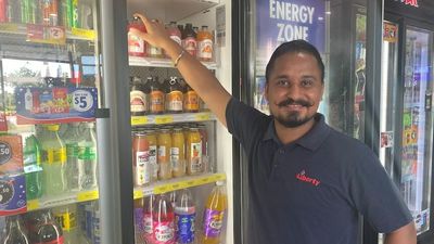 Gympie shop owner Major Singh hands out $10,000 in supplies to drivers stranded by floods