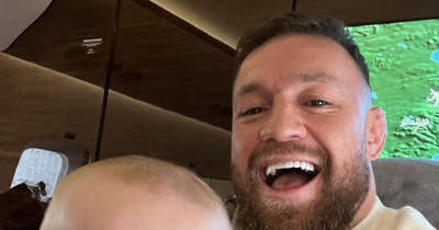 Conor McGregor shares picture with son Rian as he jets off abroad after declaring interest in buying Chelsea