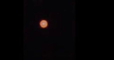 Mysterious fast-moving 'UFO' resembling the sun filmed floating across night sky