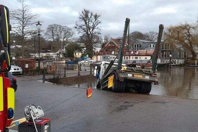 Skip lorry driver trapped after vehicle slips into the Thames