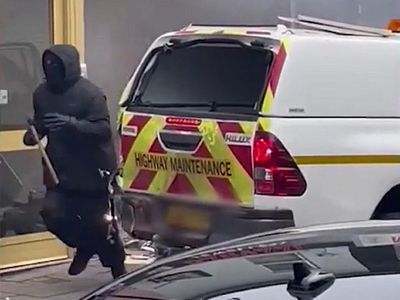 Masked man with axe screams threats at bystanders as truck ram raids jewellers