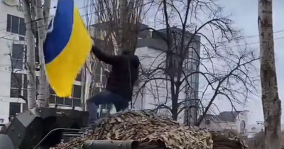 Kherson protests: Man stands on tank with Ukraine flag as thousands protest against Russia