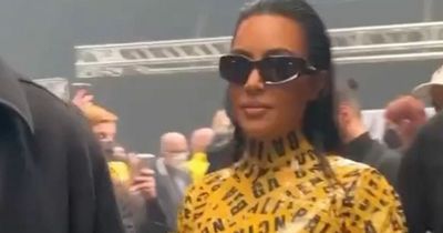 Kim Kardashian arrives at Balenciaga Paris Fashion Week show covered in yellow tape