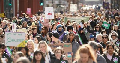 'We will never stop standing up and shouting for our rights': Hundreds take to the streets of Manchester to champion International Women's Day