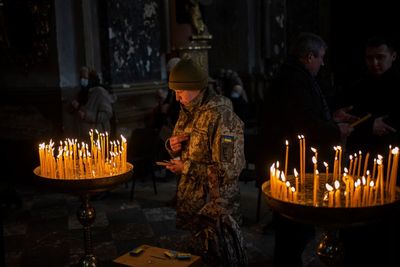 AP PHOTOS: Lviv residents seek comfort in Sunday service