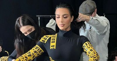 Kim Kardashian shares behind-the-scenes look of her getting ready in yellow tape outfit
