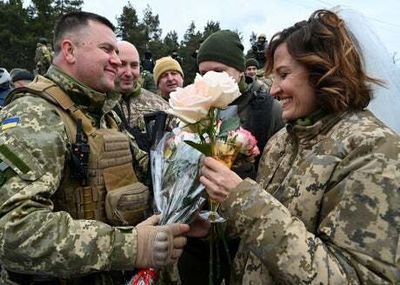 Love on the front line: Ukrainian soldiers tie the knot at Kyiv checkpoint as war rages
