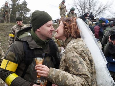 Ukrainian soldiers get married in military uniform on the frontline