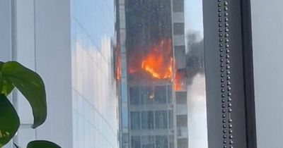 Fire crews battle huge blaze at London flats as glass panels seen crashing to ground