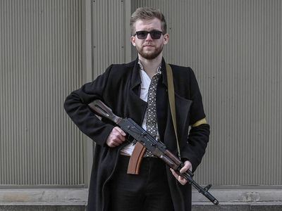 Ukraine’s youngest MP helps defend Kyiv with an AK-47 strapped to his back: ‘We either fight and survive – or we fall’