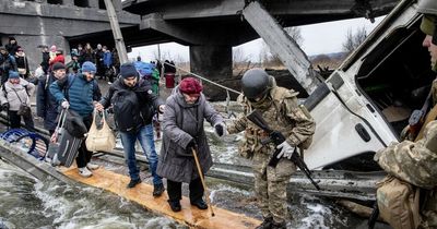Elderly woman crosses bombed bridge as Ukraine's women say 'we are brave, we will win'