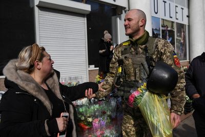 Soldiers defending Ukraine's Odessa give flowers for Women's Day