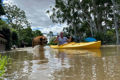 Protesters rally as Australian PM tours flood disaster