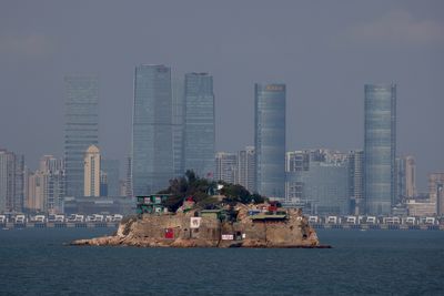 Taiwan says China is too busy with party congress to raise tensions now
