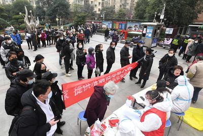 China's daily local symptomatic COVID cases nearly double to 402