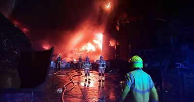 Huge blaze erupts at recycling plant as firefighters race to save nearby buildings