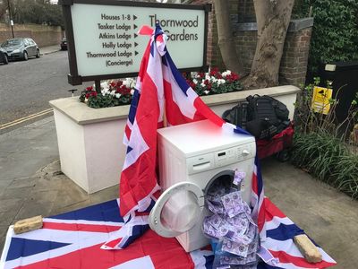 Protesting about UK dirty money in one of London’s most exclusive streets with a washing machine full of cash
