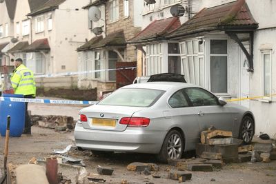 Pedestrian killed as car crashes into house